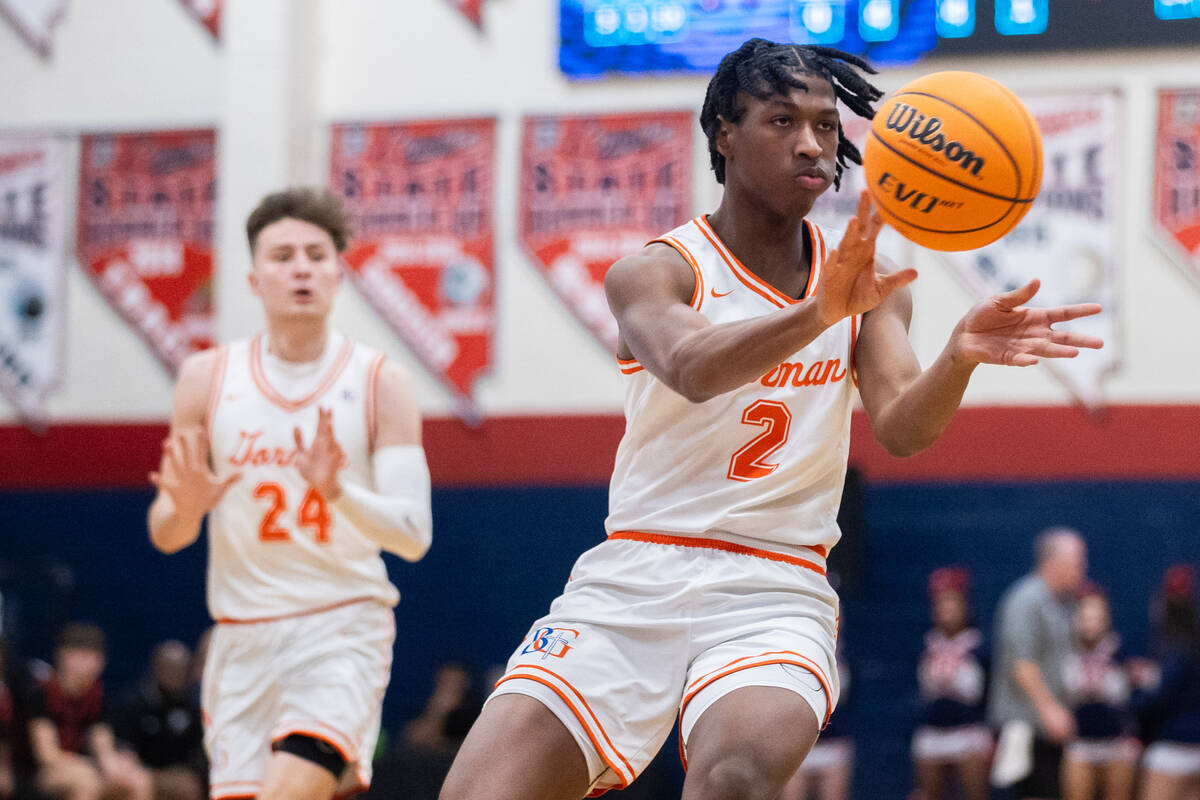 Bishop Gorman’s Jett Washington (2) passes the ball during a basketball game between Cor ...