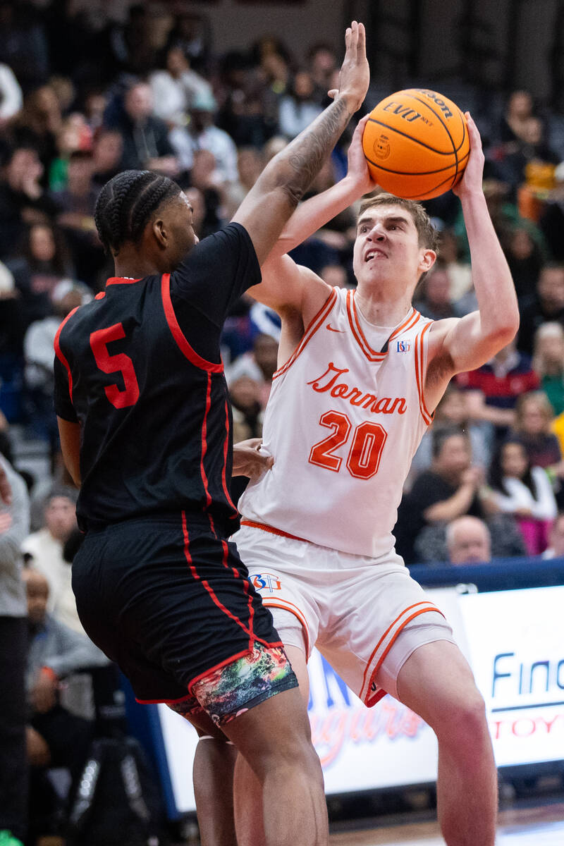 Bishop Gorman’s Ilan Nikolov (20) looks to pass the ball around Coronado’s Lantz ...