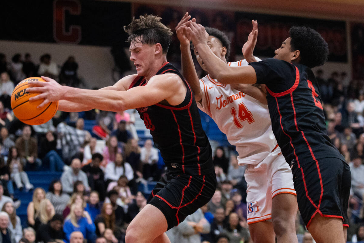 Coronado’s JJ Buchanan (10) rebounds the ball during a basketball game between Coronado ...