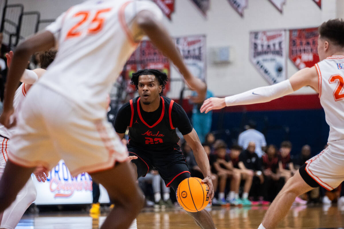 Coronado’s Josiah Cunningham (23) dribbles the ball past Bishop Gorman players during a ...