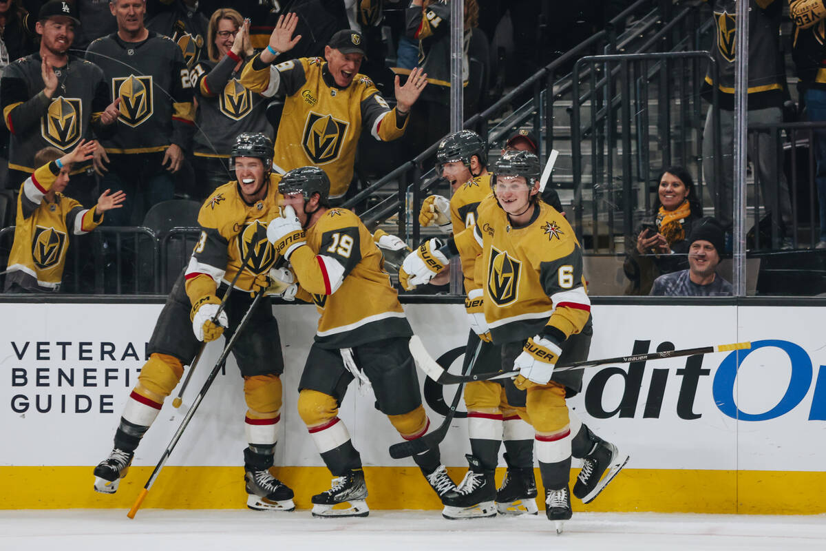 Golden Knights center Brendan Brisson (19) celebrates his first goal with his teammates during ...