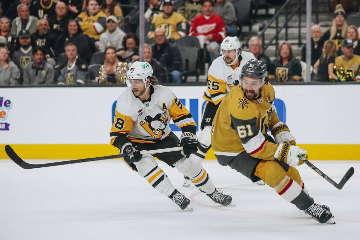 Pittsburgh Penguins defenseman Kris Letang (58) and Golden Knights right wing Mark Stone (61) s ...