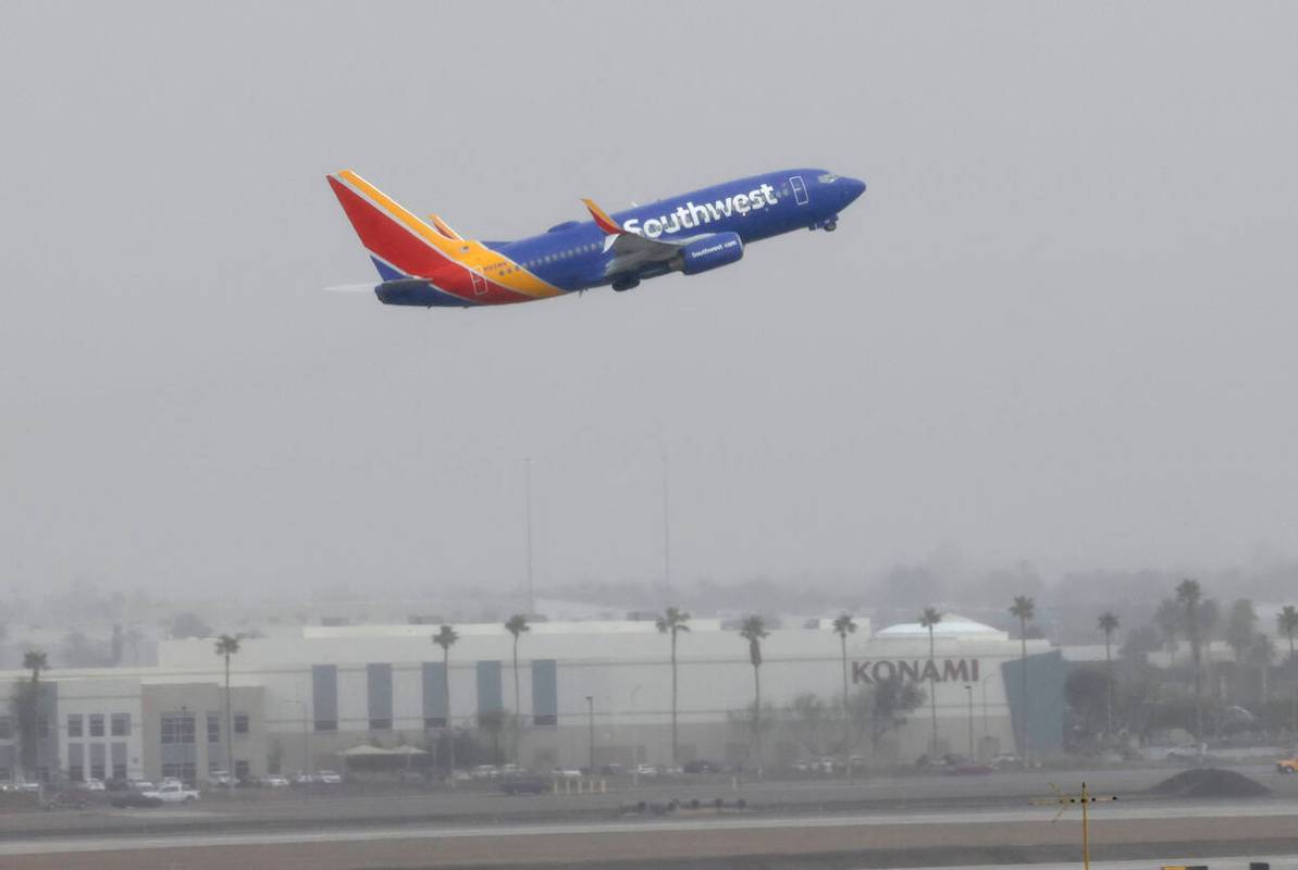 Fog lingers over Harry Reid International Airport as the Southwest Airways plane takes off, on ...