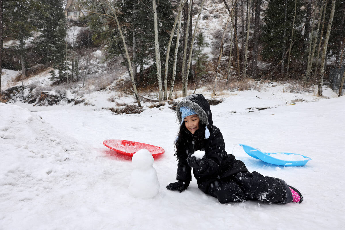 Natalie Cabrera, 8, plays in the snow off the side of the road in Kyle Canyon on Mount Charlest ...