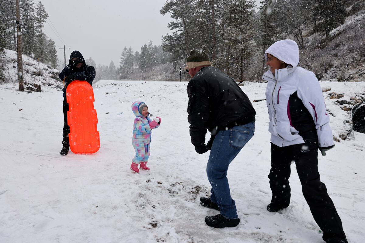 Ire-Lynn Rettinger, 2, plays in the snow with her parents Rick and and Rae-Lynn, and brother Ai ...