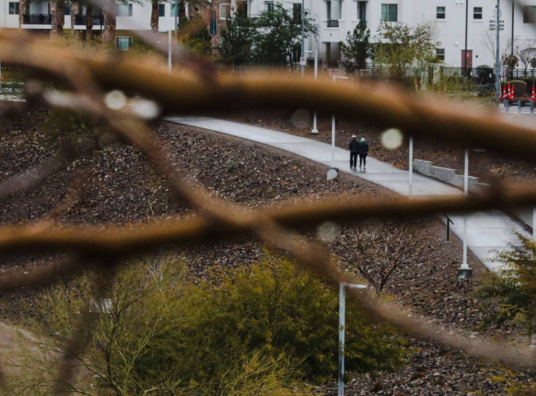 A couple walks through Cornerstone Park following the rain in Henderson, Monday, Jan. 22, 2024. ...