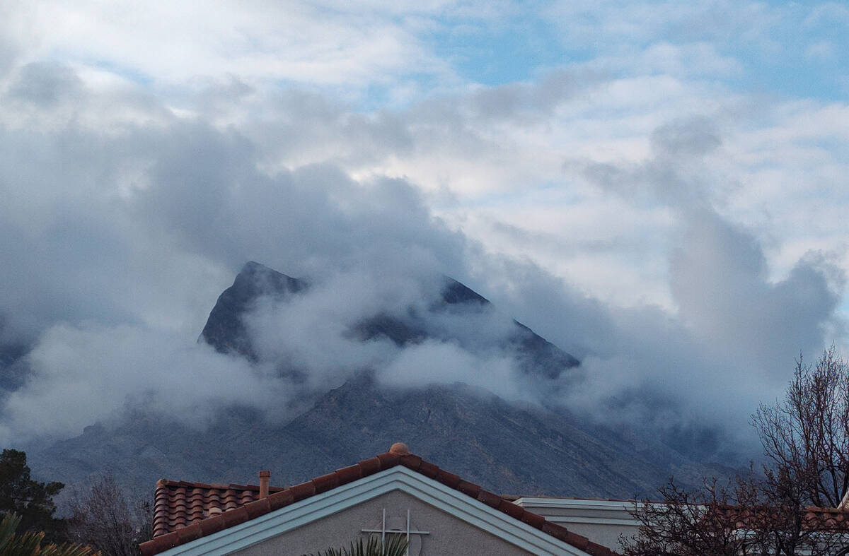 Low clouds envelop a mountaintop in Summerlin on Sunday, Jan. 21, 2024. (Marvin Clemons/Las Veg ...