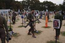 An Israeli soldier visits the site where revelers were killed on Oct. 7 in a cross-border attac ...
