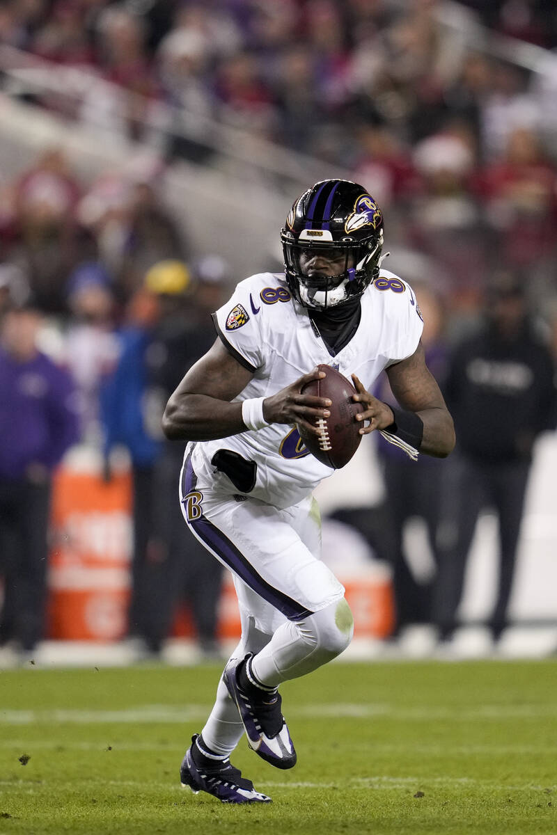 Baltimore Ravens quarterback Lamar Jackson looks for a receiver during the first half of an NFL ...