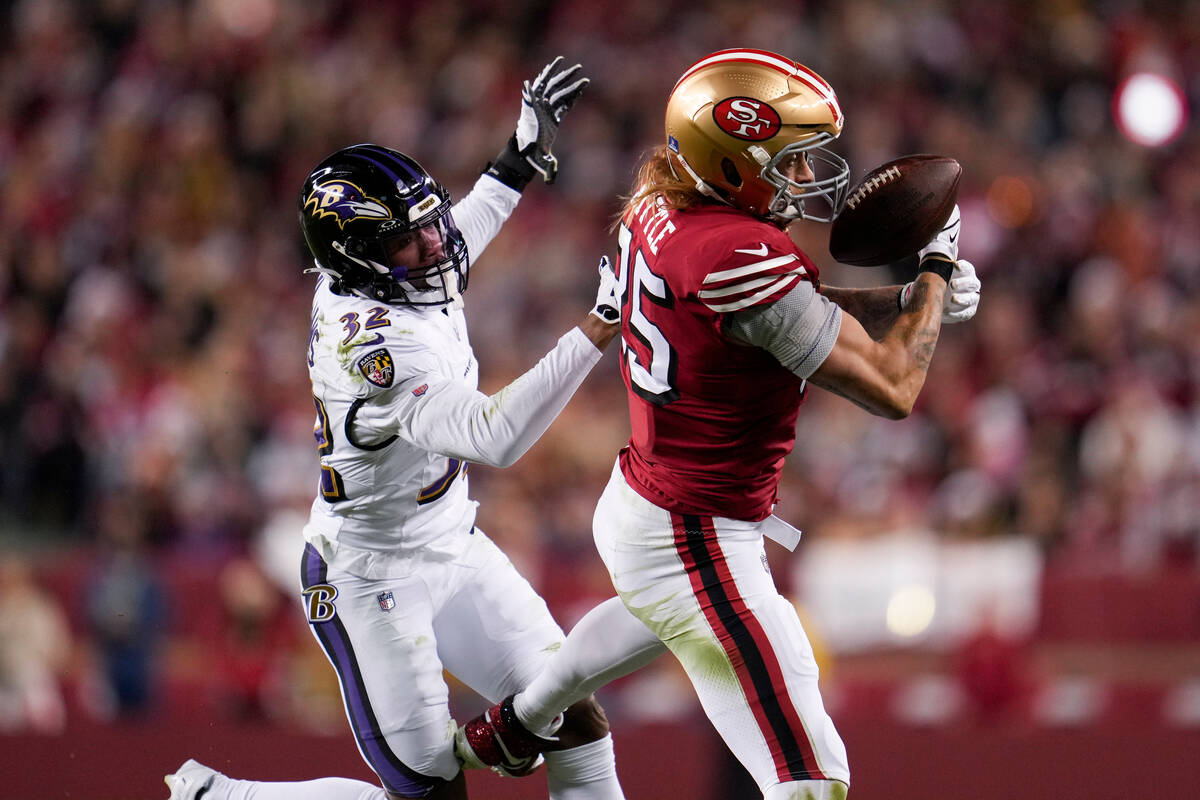San Francisco 49ers tight end George Kittle, right, is unable to catch a pass while being defen ...