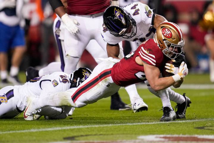 San Francisco 49ers running back Christian McCaffrey, right, scores a touchdown against Baltimo ...