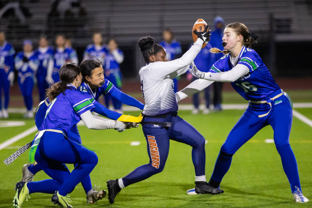 Legacy’s Mailaya Taylor (3) pushes through Green Valley players during a flag football g ...