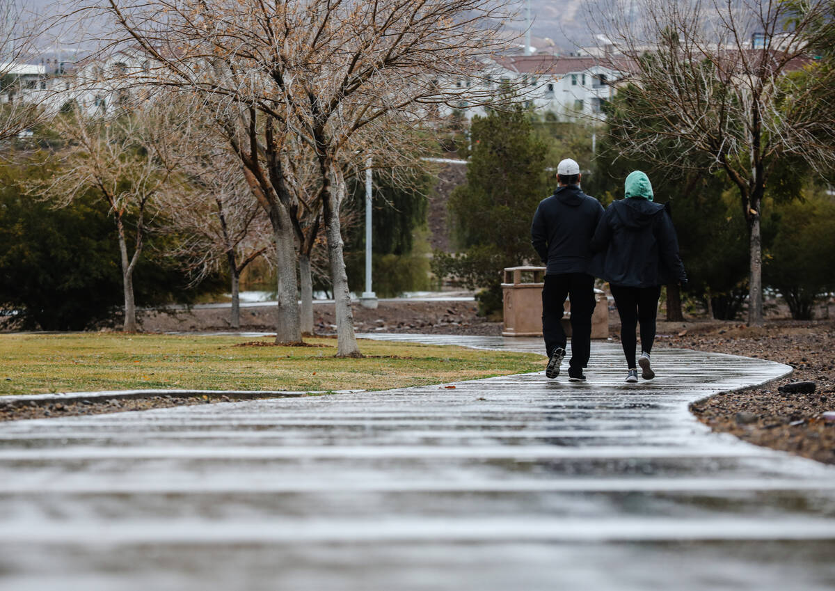 A couple walks through Cornerstone Park following the rain in Henderson, Monday, Jan. 22, 2024. ...
