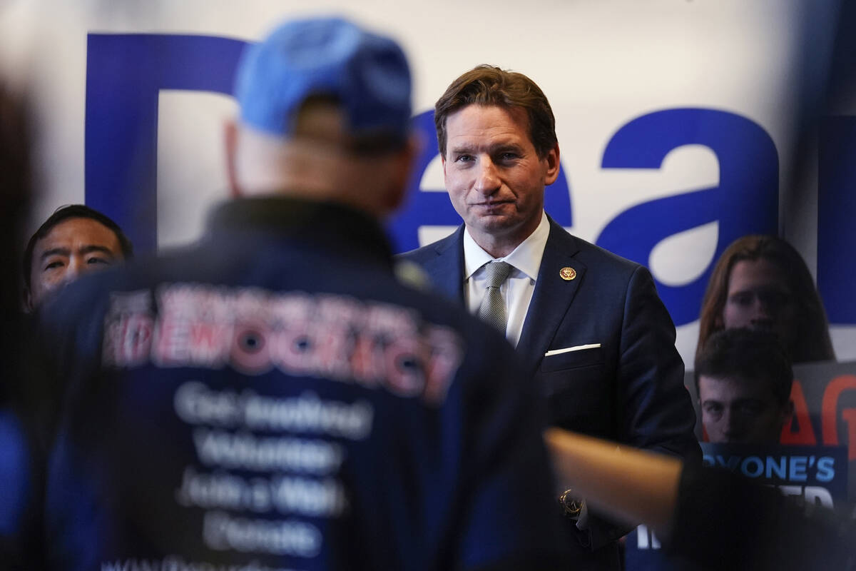 Democratic presidential candidate Rep. Dean Phillips, D-Minn., right, listens to a question dur ...