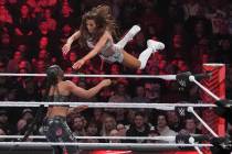 Wrestler Carmella leaps at Bianca Belair, during the WWE Monday Night RAW event, March 6, 2023, ...