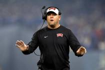 UNLV Rebels head coach Barry Odom communicates from the sidelines during the first half of the ...
