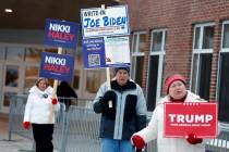 Candidate supporters stand outside the Windham High School polling place in the presidential pr ...