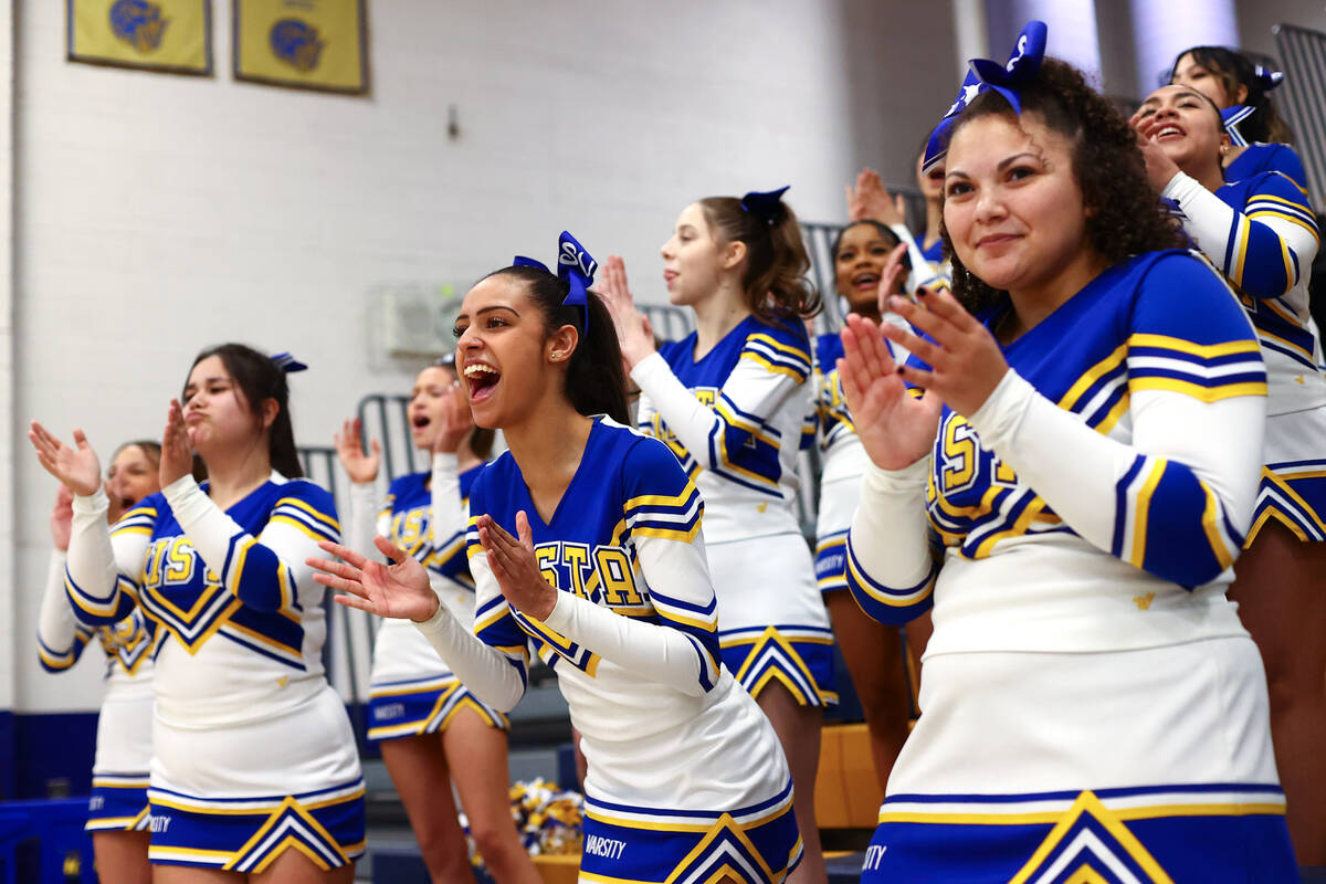 Sierra Vista cheerleaders pump up their team during the second half of a high school basketball ...