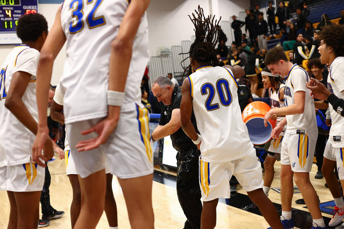 Sierra Vista players dump a water cooler on head coach Joseph Bedowitz to celebrate his 100th c ...