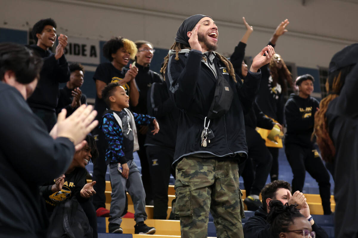 Clark fans cheer for their team during the second half of a high school basketball game against ...