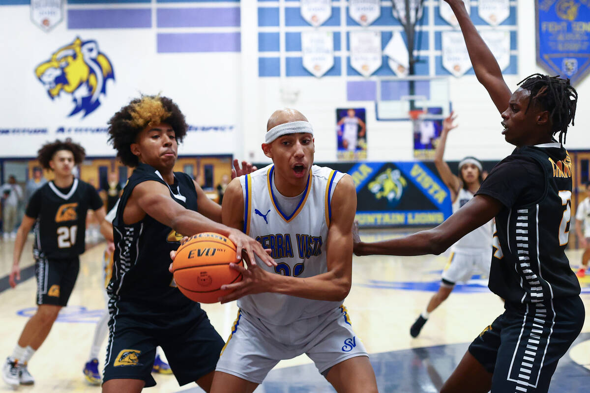 Sierra Vista center Xavion Staton (32) struggles for the ball with Clark guard Elijah Coleman, ...