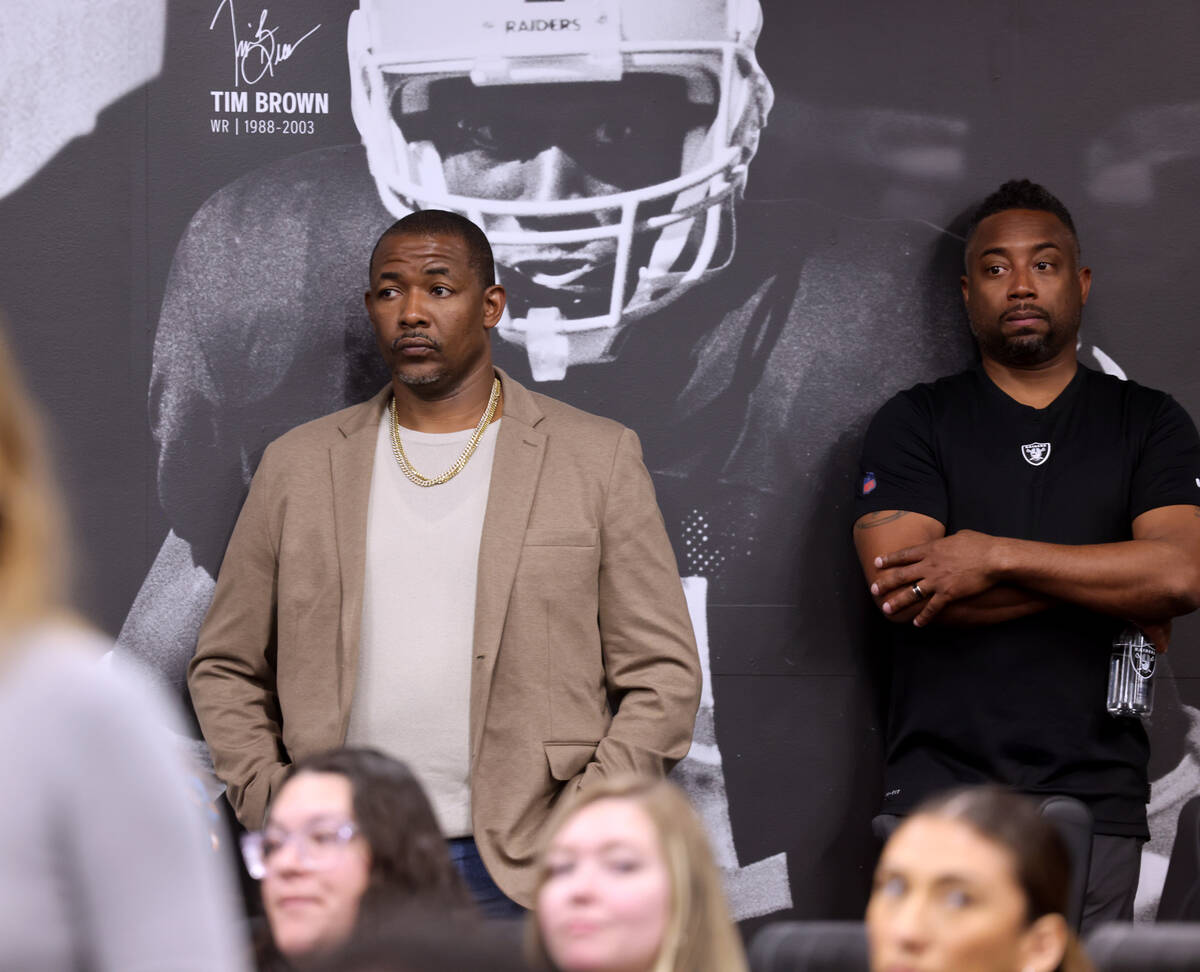 Raiders defensive coordinator Patrick Graham, left, watches during a press conference to introd ...