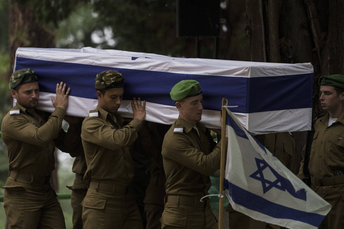 Israeli soldiers carry the flag-draped casket of reservist Sgt. first class Nicholas Berger dur ...