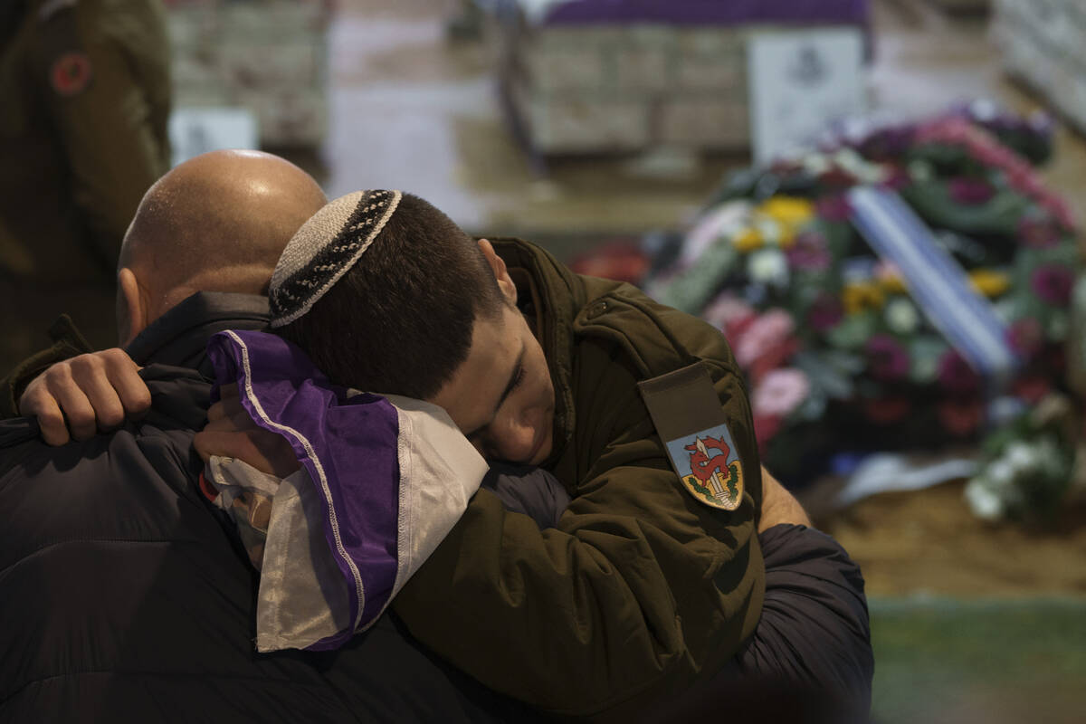Family and friends of Israeli reservist Sgt. first class Nicholas Berger mourn during his funer ...