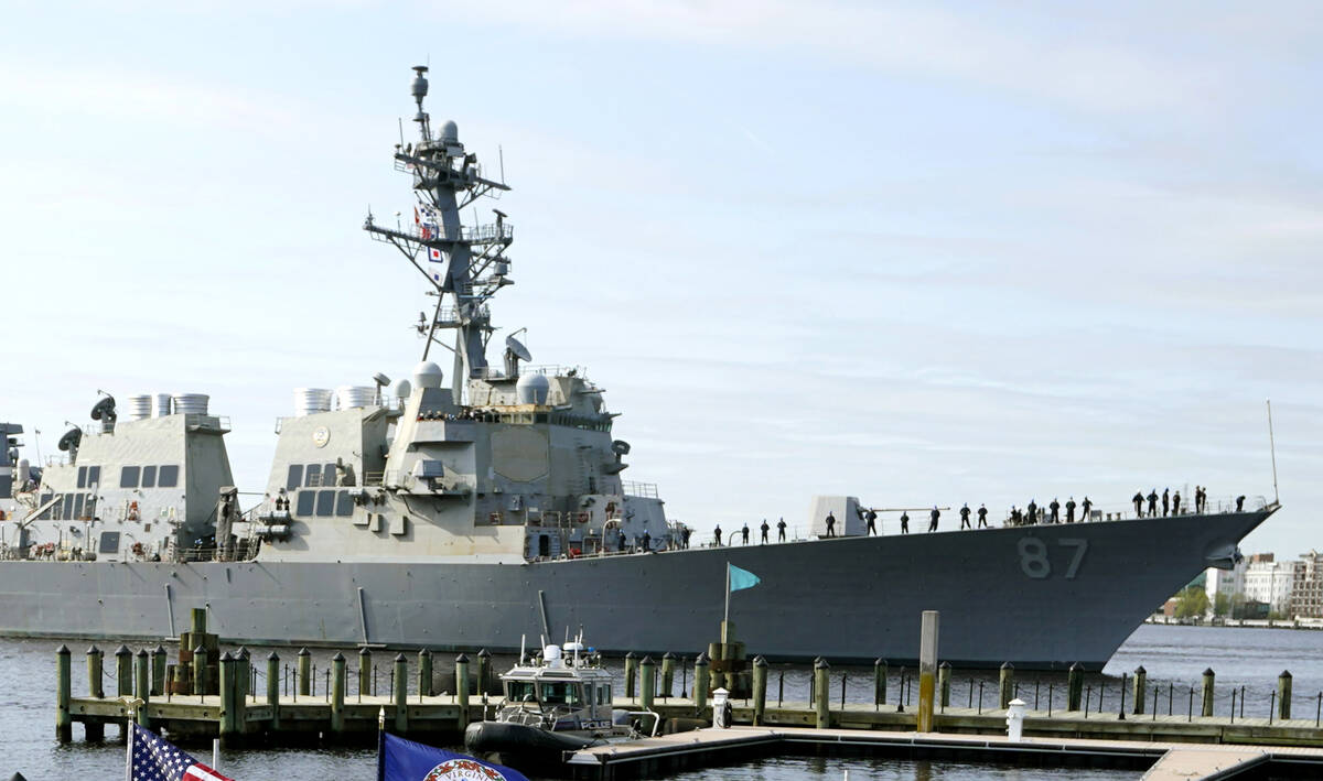 File - The USS Mason, an Arleigh Burke-class destroyer, passes a dock in Norfolk, Va., April 8, ...