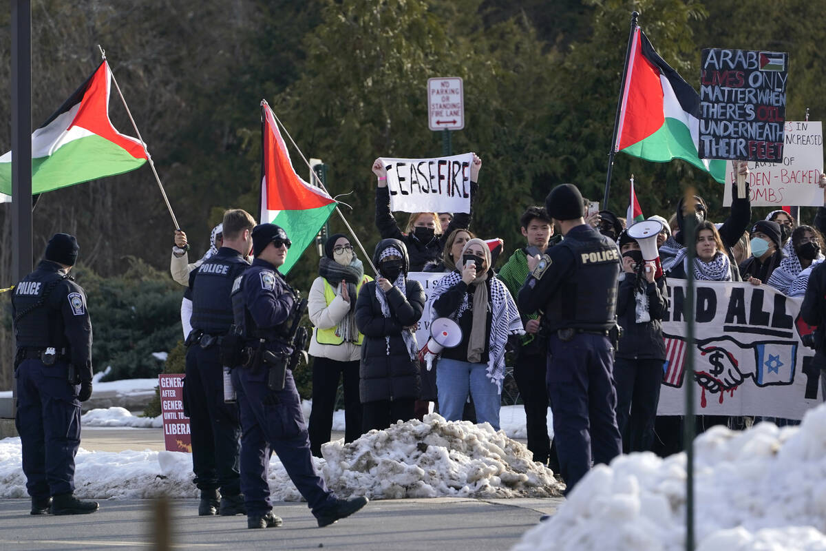 Protestors gather outside where President Joe Biden is to speak at an event on the campus of Ge ...