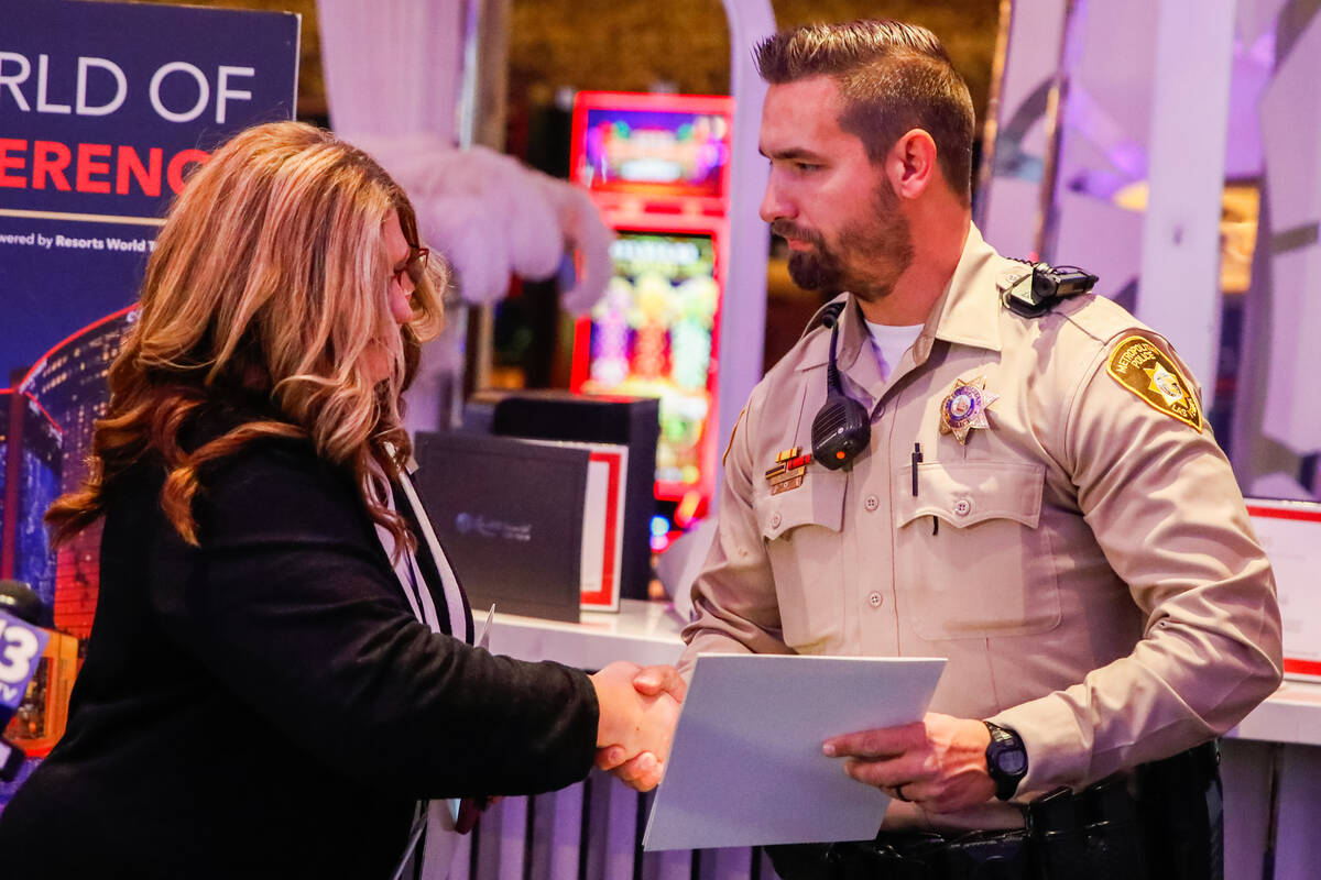 Karen Marben, executive director of the LVMPD Foundation, honors officer Jacob Noriega with the ...