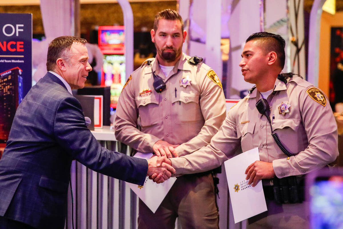 Brian Spellacy, director of security at Resorts World, honors officers Jacob Noriega and Ty Ves ...