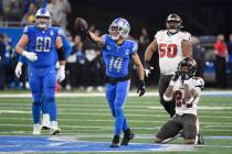 Detroit Lions' Amon-Ra St. Brown (14) reacts after catching a pass for a first down in front of ...