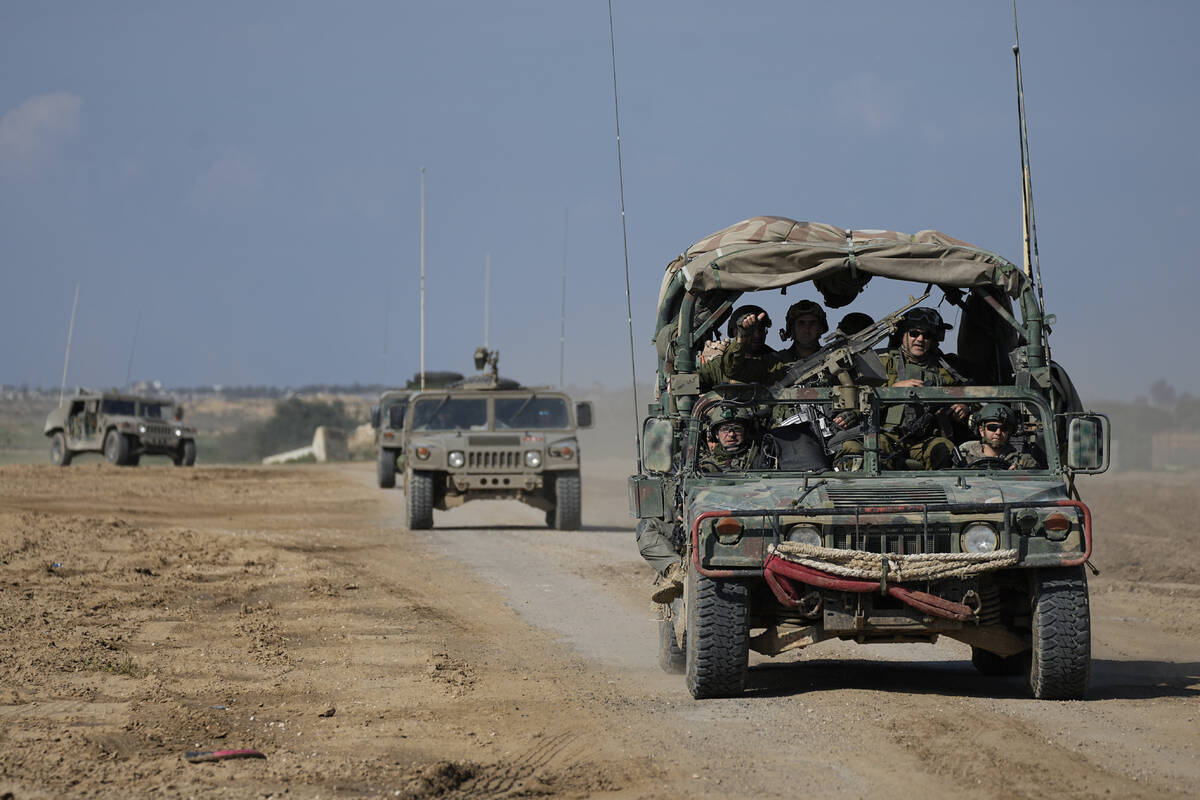 Israeli forces move near the Gaza Strip border in southern Israel, Thursday, Jan. 25, 2024. The ...