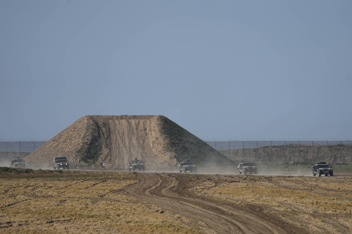 Israeli forces move near the Gaza Strip border in southern Israel, Thursday, Jan. 25, 2024. The ...