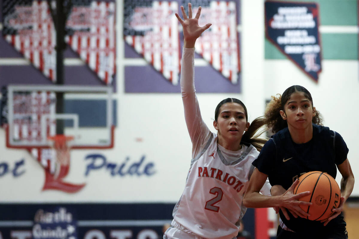 Liberty's Lillian Hastings (2) defends while Spring Valley's Charolette Delisle (21) drives tow ...