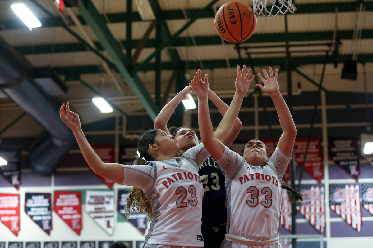Spring Valley's Jada Green (23) shoots while Liberty's Xasia Smith (23) and Leiliani Harworth ( ...