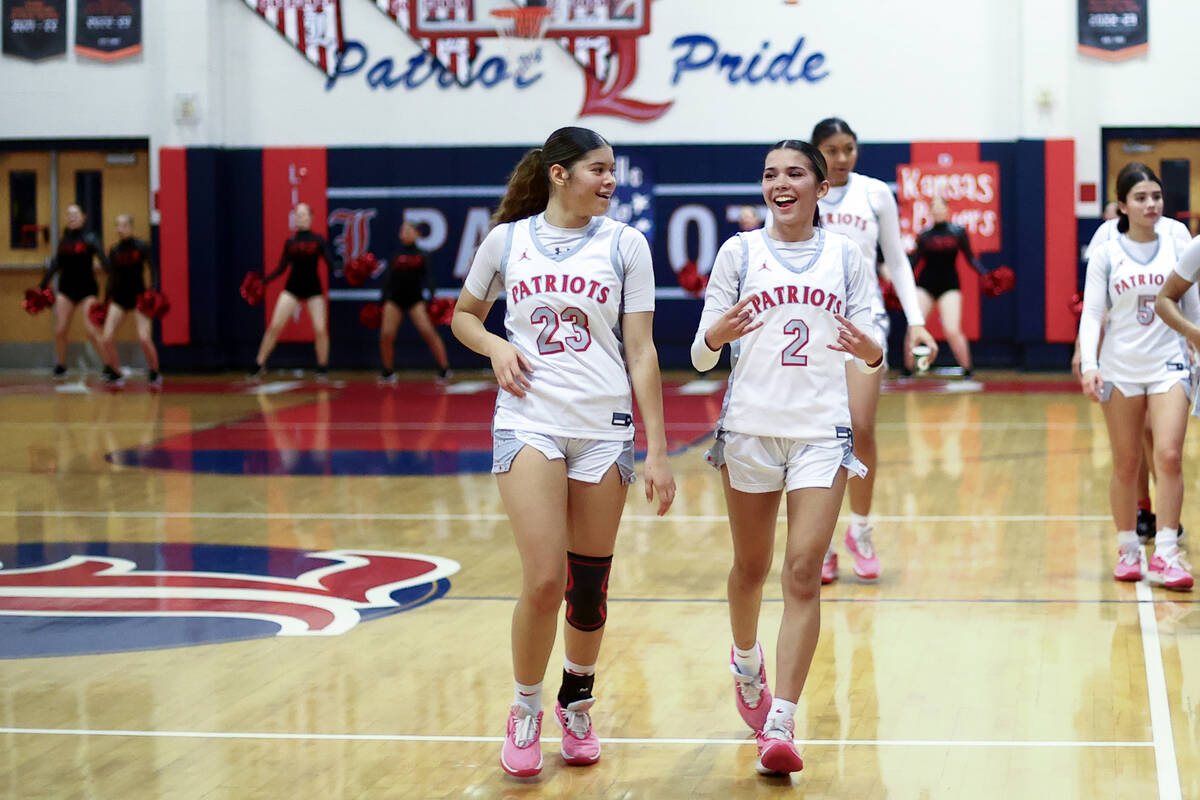 Liberty's Xasia Smith (23) and Liberty's Lillian Hastings (2) are pleased after winning a high ...