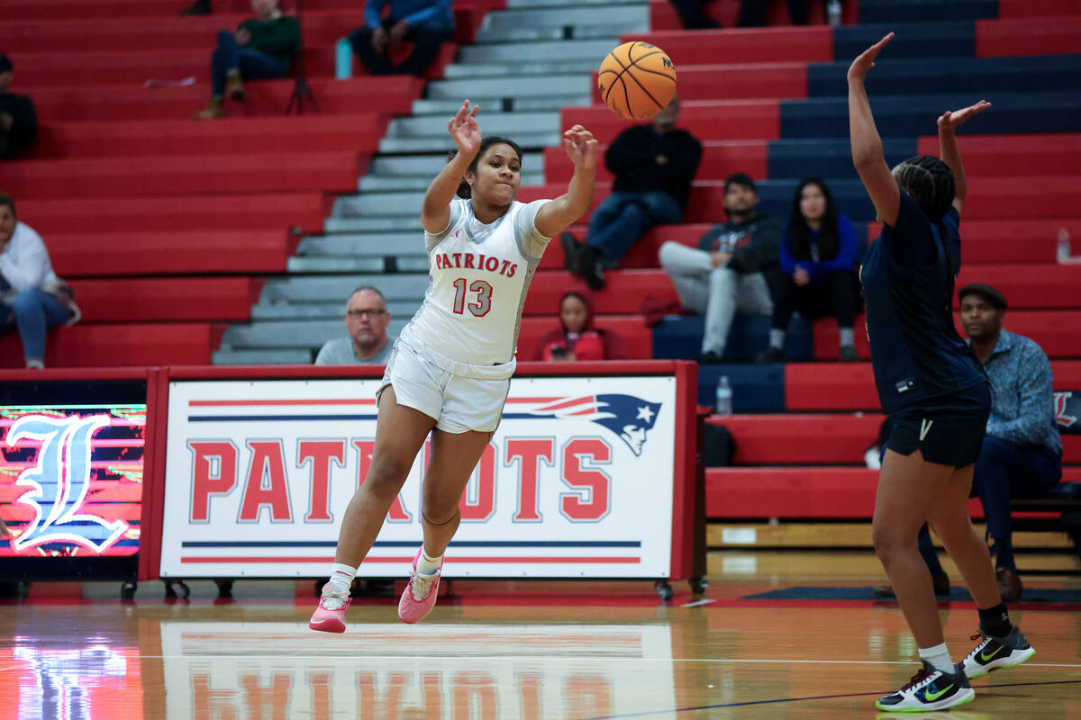 Liberty's Aiyanna Eteuini (13) passes up the court against Spring Valley's Mi'yana Stephens (4) ...