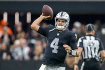 Raiders quarterback Aidan O'Connell (4) throws the football to stay loose on the sideline durin ...