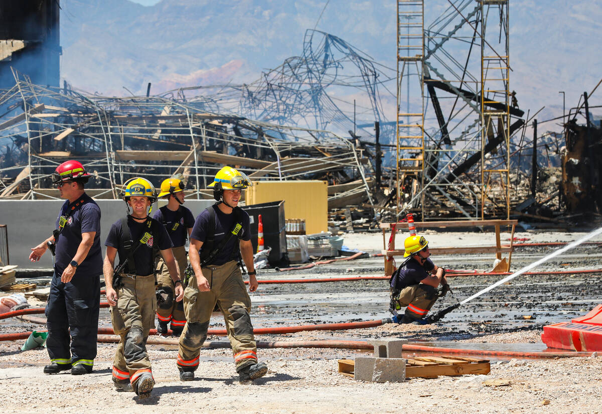 Firefighters work on a fire in an apartment complex under construction at 8030 W. Maule Ave on ...