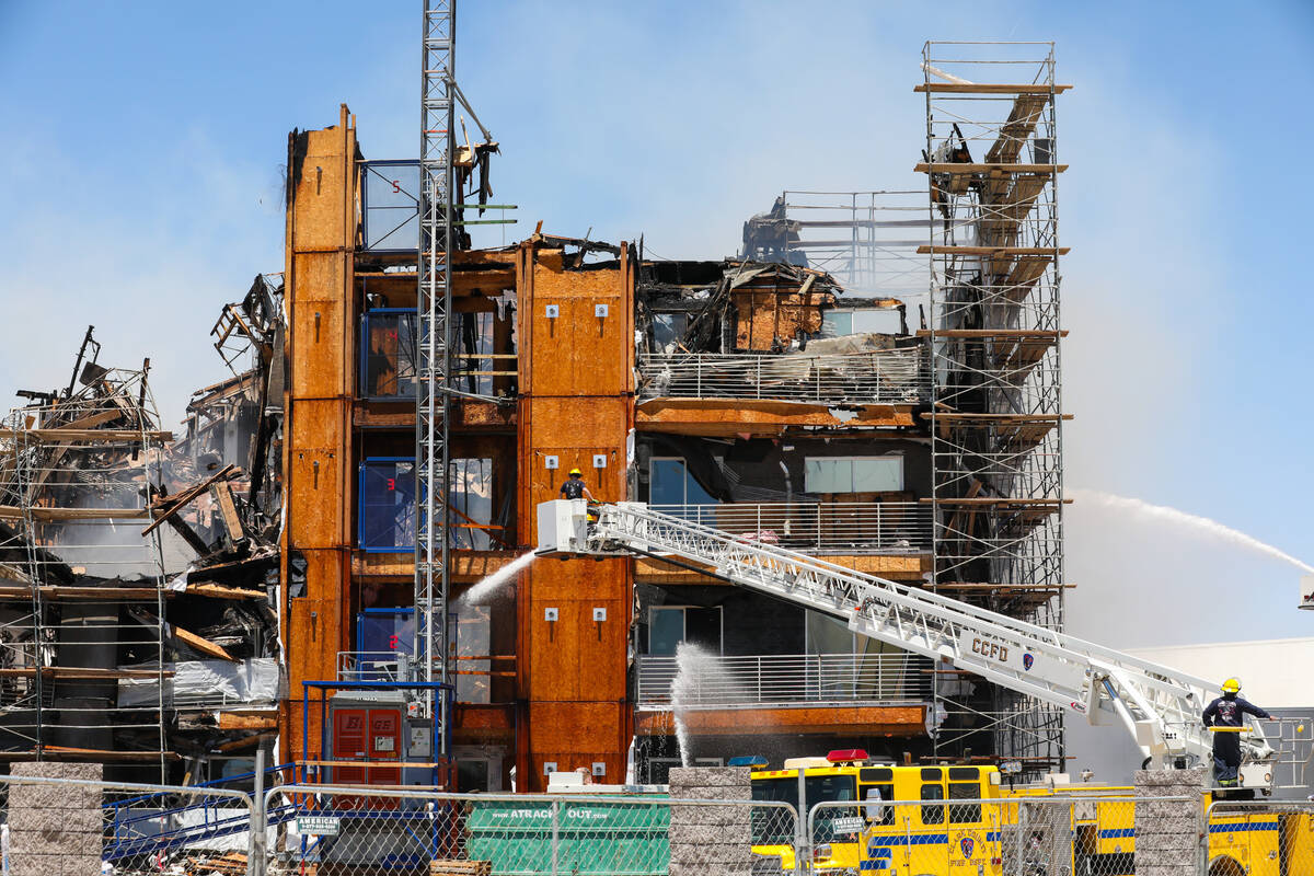 Firefighters work on a fire in an apartment complex under construction at 8030 W. Maule Ave on ...