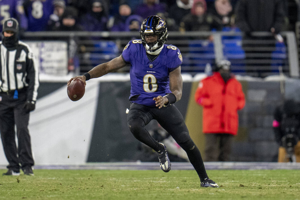 Baltimore Ravens quarterback Lamar Jackson runs with the ball against the Houston Texans during ...