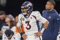 Denver Broncos quarterback Russell Wilson (3) watches the team play during the second half of a ...