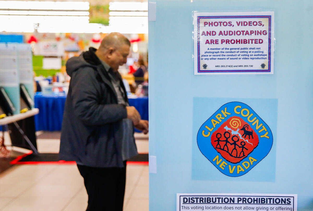 A voter casts his ballot during the early voting period at Seafood City Market on Saturday, Jan ...