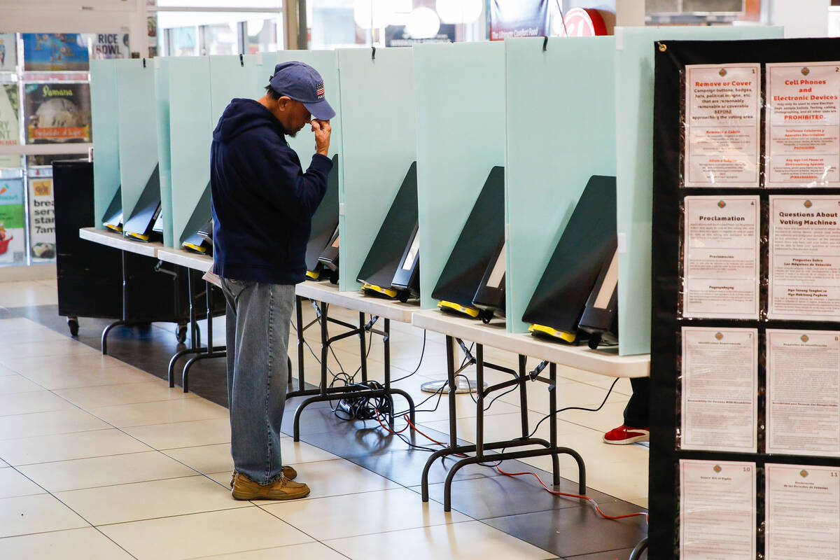 Eliseo Flores casts his vote during the early voting period at Seafood City Market on Saturday, ...