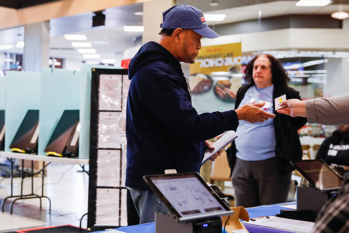 Eliseo Flores checks in for early voting at Seafood City Market on Saturday, Jan. 27, 2024 in L ...