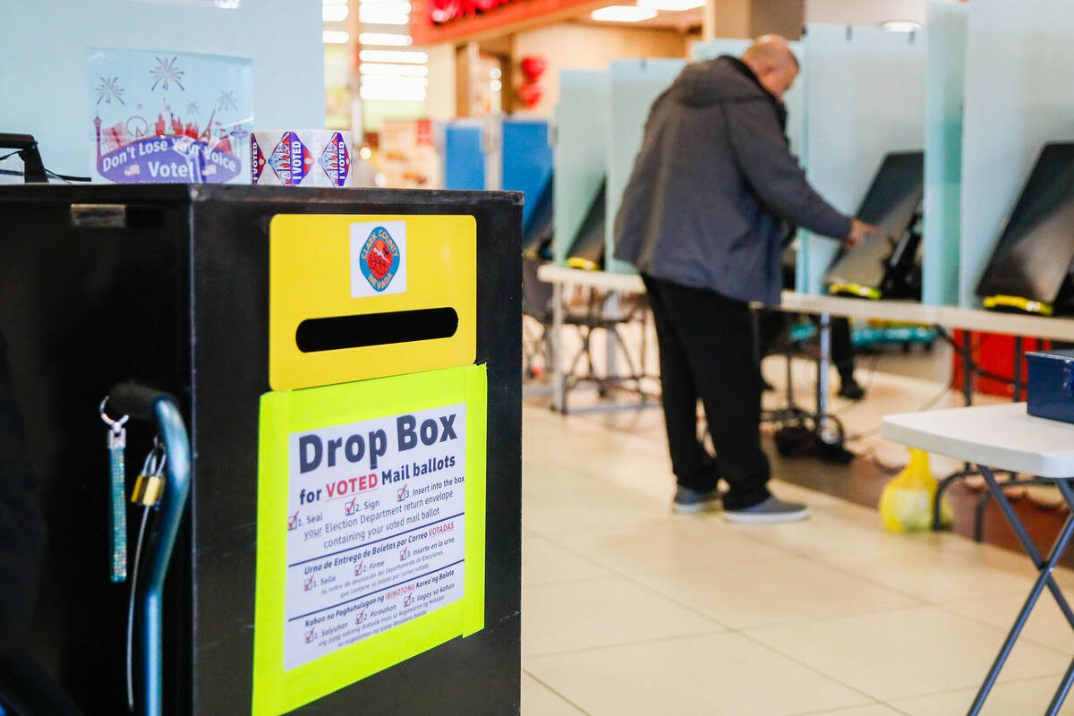 A voter casts his vote during the early voting period at Seafood City Market on Saturday, Jan. ...