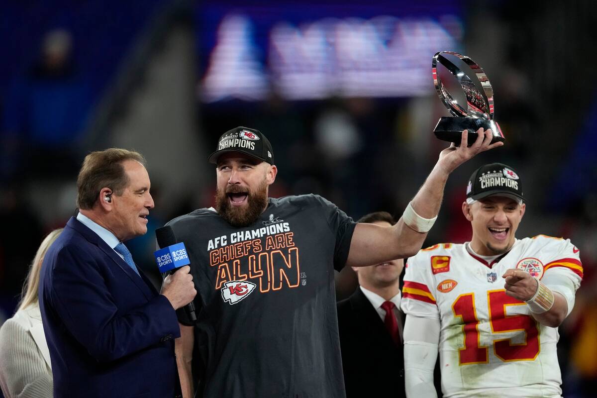 Kansas City Chiefs tight end Travis Kelce (87) holds a trophy after the AFC Championship NFL fo ...