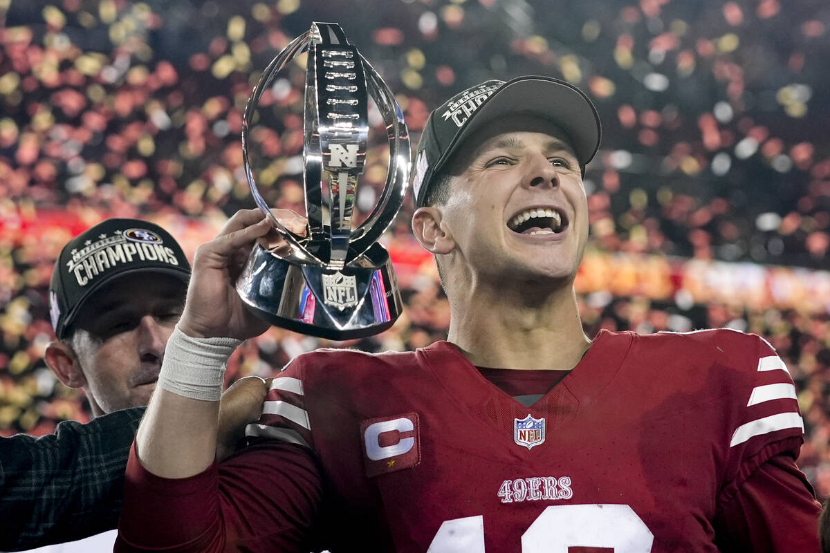 San Francisco 49ers quarterback Brock Purdy celebrates with the trophy after their win against ...